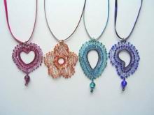 Intricate pendants on ribbon necklaces.jpg